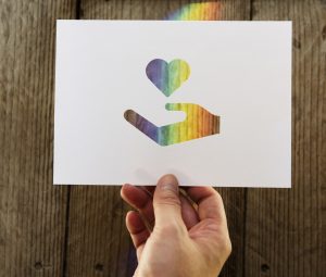 Donation symbol outstretched hand fundraising icon and rainbow