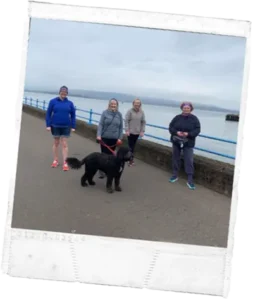 Mental Health Mates walk along the seafront with a dog